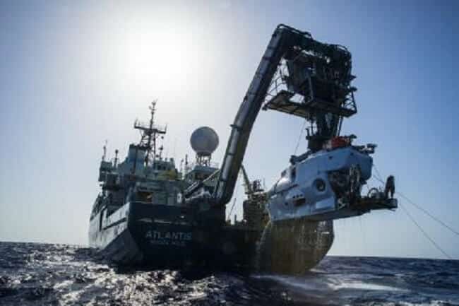 The research vessel Atlantis with the submersible Alvin hanging off its stern. (credit: Luis Lamar, Woods Hole Oceanographic Institution)