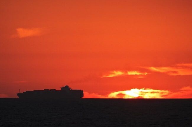 silhouette sunset container ship