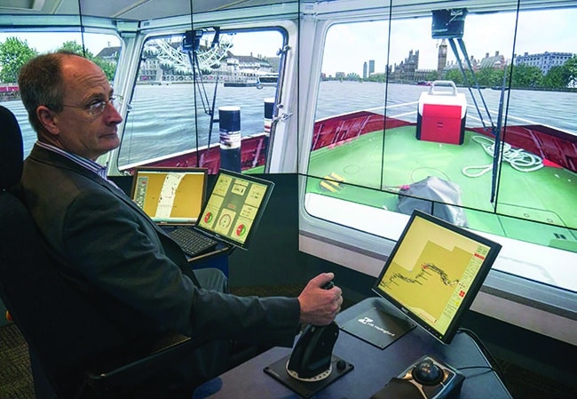 Andy Mitchell, Tideway CEO , at the helm of a tug in the HR Wallingford River Thames simulation
