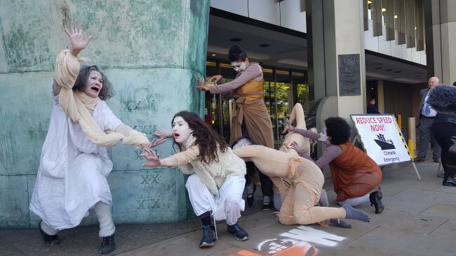 Climate Change Protesters Dance In Front Of IMO HQ