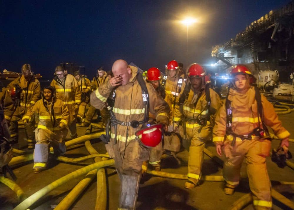 SAN DIEGO (July 16, 2020) Sailors depart the amphibious assault ship USS Bonhomme Richard (LHD 6) after combating a fire on board. On the morning of July 12, a fire was called away aboard the ship while it was moored pier side at Naval Base San Diego. Base and shipboard firefighters responded to the fire. Bonhomme Richard is going through a maintenance availability, which began in 2018.