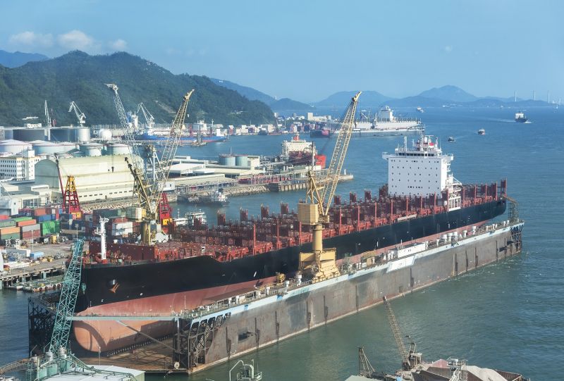 A large tanker ship is being renovated in shipyard