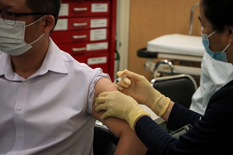 Man being vaccinated against Covid-19, Macau, China