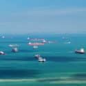shipping, transport and seafaring concept - boats sailing in ocean