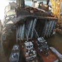 Tugs use fire monitors to control a fire inside the Golden Ray wreck