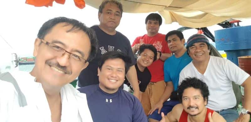 Seafarers from MV Angelic Power on a service boat after finally being able to sign off from the ship