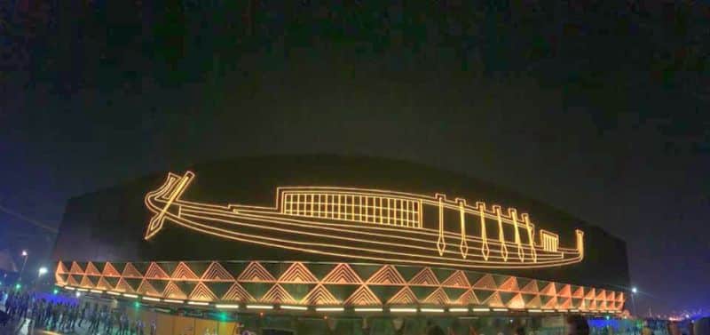 the solar powered ship of King Khufu being transported at night with lights ON, showing the design of an ancient Egyptian boat on the side