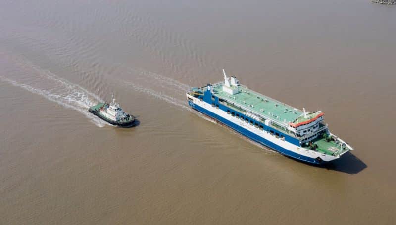 Inland vessel sailing muddy brown waters