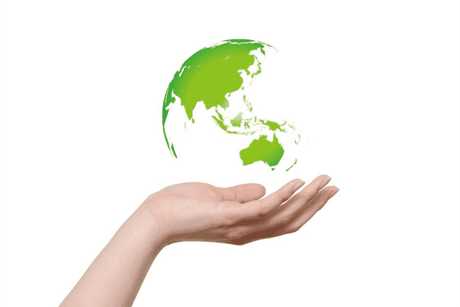 a green earth held in a hand