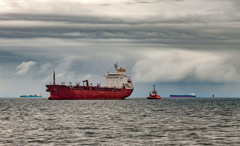 tanker ship anchored with grey skies above it