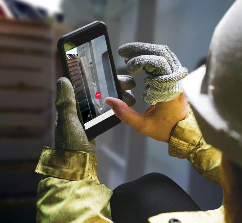 Architect holding a smartphone on construction site. young const