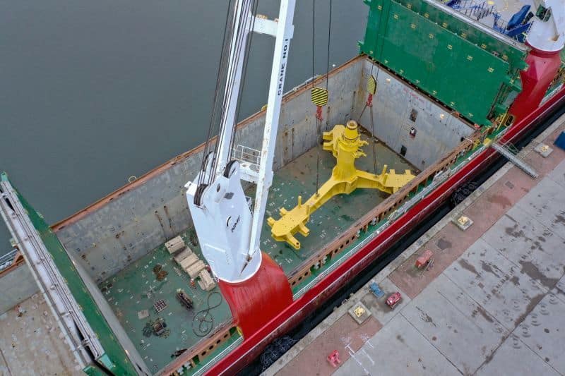 A 175 MT base foundation is loaded into hold number two of the MV Josef using the on-board cranes.