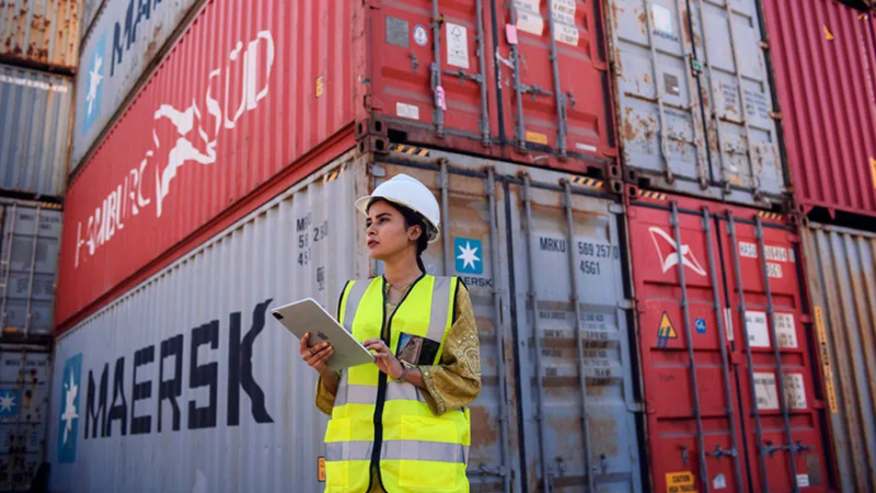 Lady port worker with maersk containers
