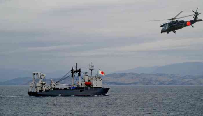 Chinese Naval Helicopter Flying Close To Japanese Ship
